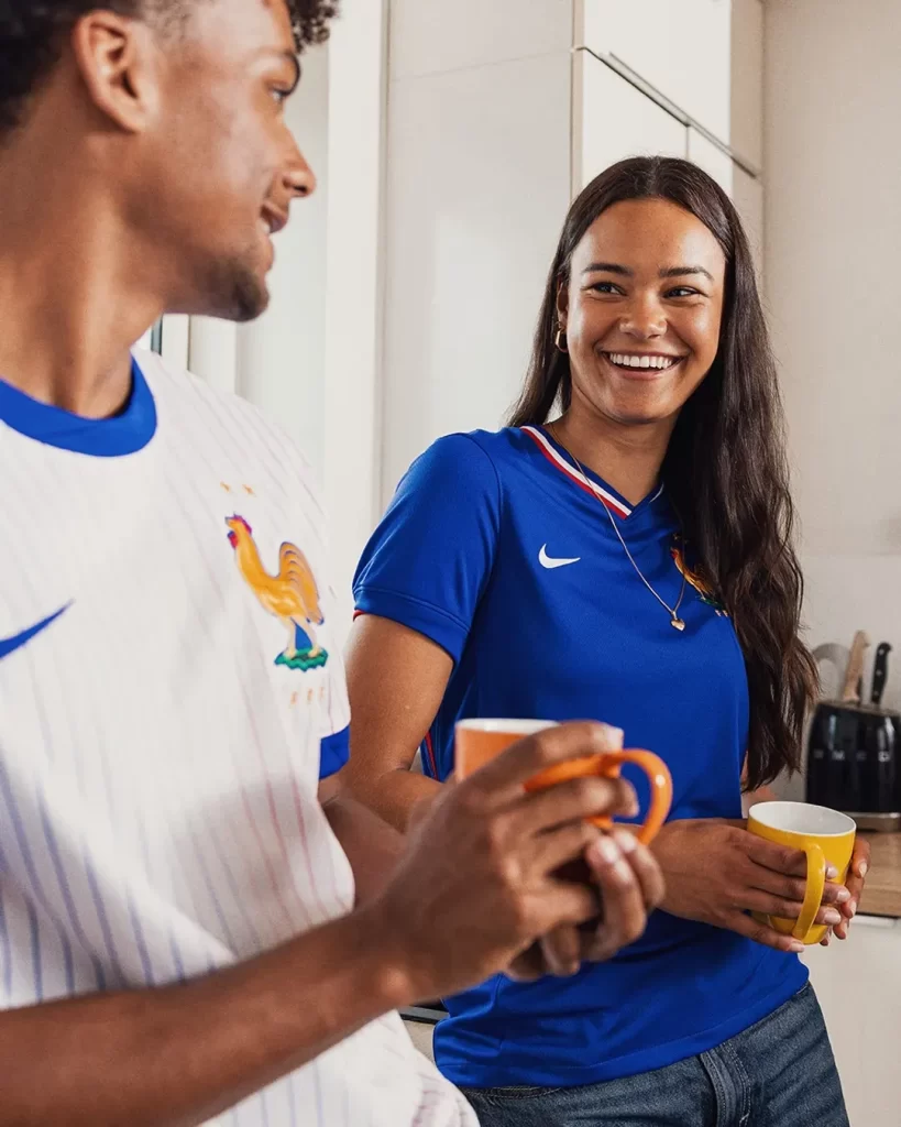 Deux supporters souriants portant les maillots blanc et bleu de l’équipe de France